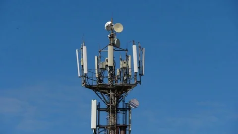 Telecommunication cellular tower against blue sky Stock Footage