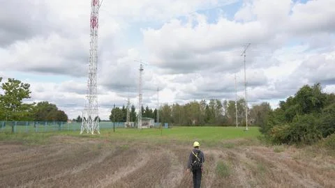 Telecommunication engineer going to 5G site for tower repair and maintenance. Stock Photos