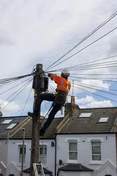 Telecommunication engineer working on a telephone pole. Stock Photos
