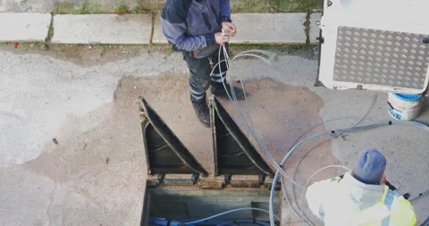 Telecommunication technician proceeds with the cabling of fibre optic cables. Video stock 227173583