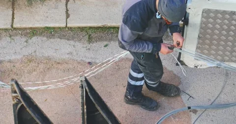 Telecommunication technician proceeds with the cabling of fibre optic cables. Video stock 230243902