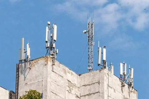 Telecommunication tower with 5G cellular network antenna on city background Stock Photos