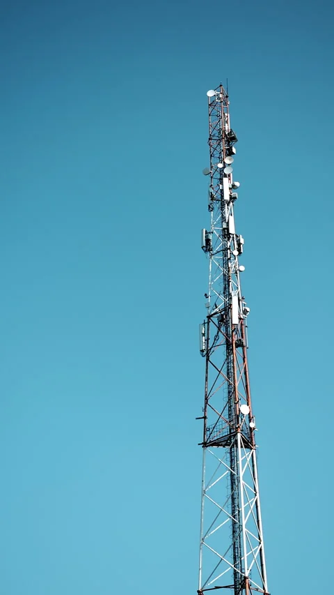Telecommunication Tower With Antennas Against Clear Blue Sky Stock Footage 345560143