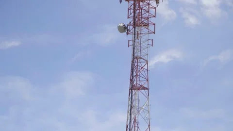 A telecommunication tower in the background a blue sky Stock Footage 310409761