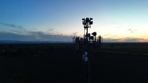 Telecommunication tower with cellular panels and microwave dishes above the Po Stock Footage 343046496