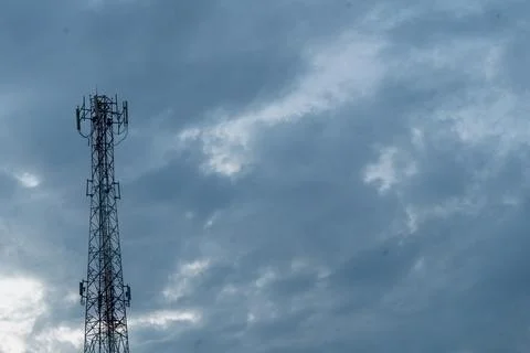 Telecommunication Tower with Cloudy Sky Background Stock Photos