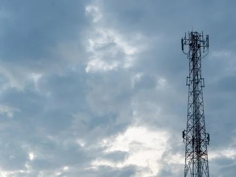 Telecommunication Tower with Cloudy Sky Background Stock Photos