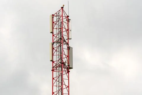 Telecommunication tower on cloudy sky Stock Photos