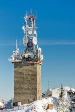 Telecommunication tower with dish and mobile antennas Stock Photos