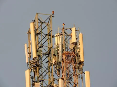 Telecommunication tower equipped with multiple cellular antennas Stock Photos