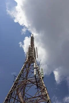Telecommunication tower extending into cloudy blue sky on Mount Pantokrator 写真素材