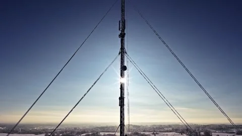 Telecommunication tower providing wireless connectivity across snowy winter Stock Footage 331336899