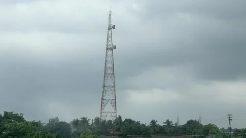Telecommunication Tower Under Dark Monsoon Clouds in Rural India Video stock 341717243