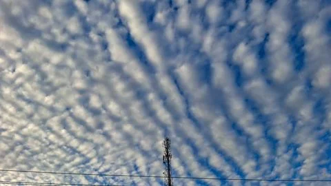 Telecommunication tower under dramatic cloudscape sky Stock Photos