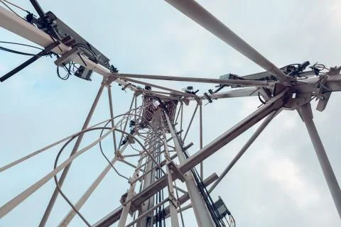 Telecommunication tower with vertical panel antenna and remote radio unit, power Stock Photos