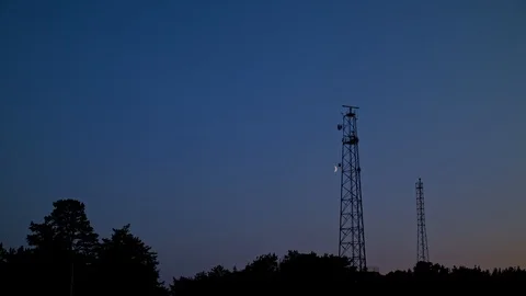Telecommunication towers with the Moon passing by 動画素材 95374546