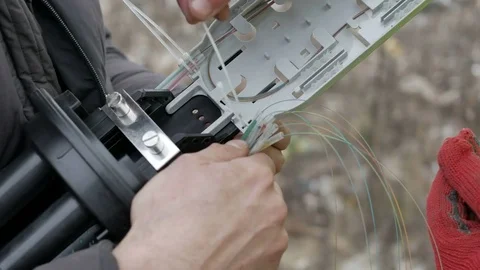 Telecommunications engineer working with optical coupling Stock Footage 70197563