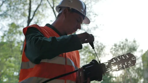 Telecommunications engineer working with optical coupling Stock Footage 89238299