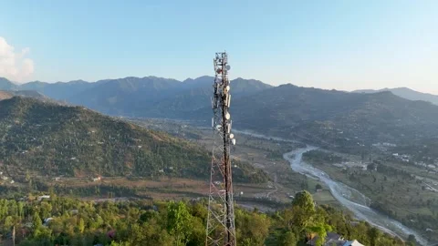 Telecommunications infrastructure in remote mountain terrain Stockbeeldmateriaal 348470307