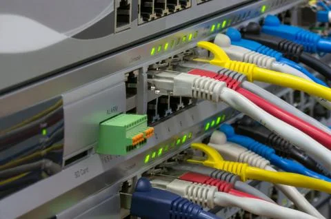 Telecommunications switches with colored patch cords Stock Photos