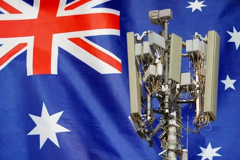 Telecommunications tower with a 5G cellular network antenna agains flag of Au Stock Photos