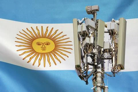 Telecommunications tower with a 5G cellular network antenna agains flag of Ar Stock Photos