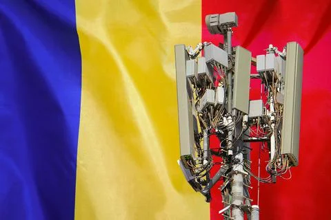 Telecommunications tower with a 5G cellular network antenna agains flag of Mo Stock Photos