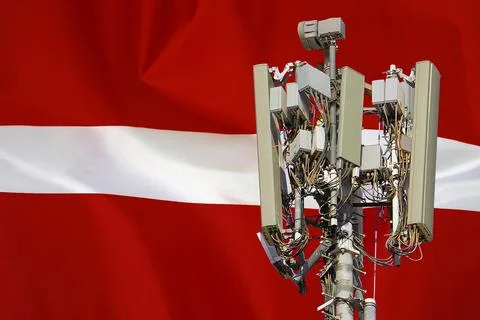 Telecommunications tower with a 5G cellular network antenna agains flag of La Stock Photos
