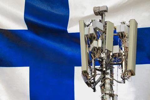 Telecommunications tower with a 5G cellular network antenna agains flag of Fi Stock Photos