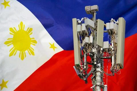 Telecommunications tower with a 5G cellular network antenna agains flag of Ph Stock Photos