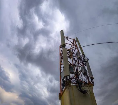 Telecommunications Tower Against Dramatic Cloudy Sky Stock Photos