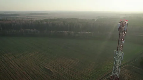 Telecommunications tower on the background of a freight train in the countryside Stockbeeldmateriaal 169493996