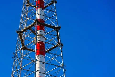 Telecommunications tower on blue sky background. close up Stock Photos