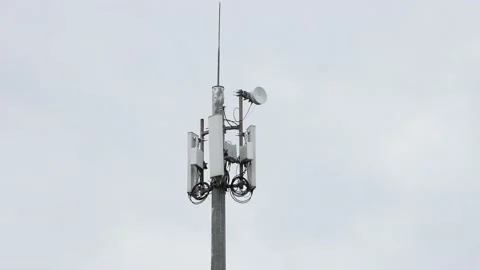 Telecommunications tower carrying broadcasting antennas for gsm, 3G, 4G and 5G Stock Footage 202024399