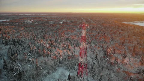 Telecommunications tower in the middle of a snow-covered forest near the village Video stock 221706773