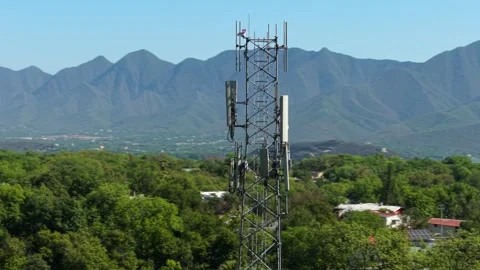 Telecommunications Tower with Mountain Backdrop Stockbeeldmateriaal 308669957