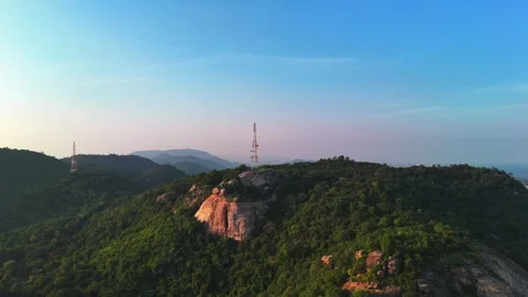 Telecommunications tower on the mountain while a beautiful sunset. Aerial view Stock Footage 294490400