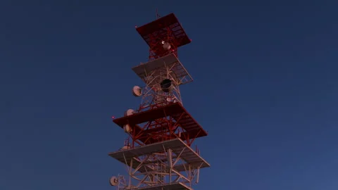 Telecommunications Tower with Red Warning Lights Against Deep Blue Twilight Sky. Stock Footage 337912770