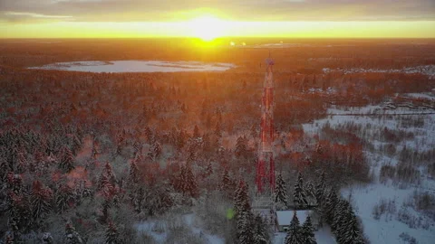 Telecommunications tower view from drone located in middle of snowy forest near 스톡 동영상 223956930