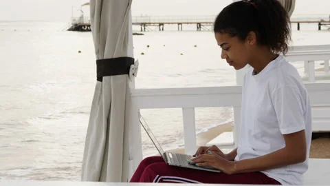 Telecommuting. Side view of cheerful young woman making video call while working Stock Footage 149439832