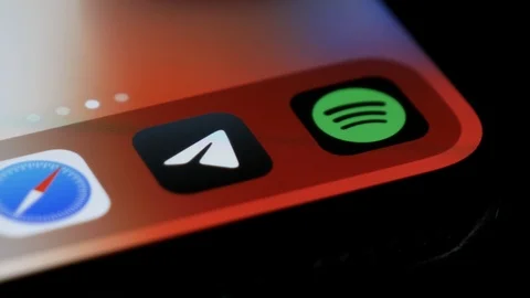 Telegram application icon. Opening the app by fingertip on the iPhone. 스톡 동영상 123890822