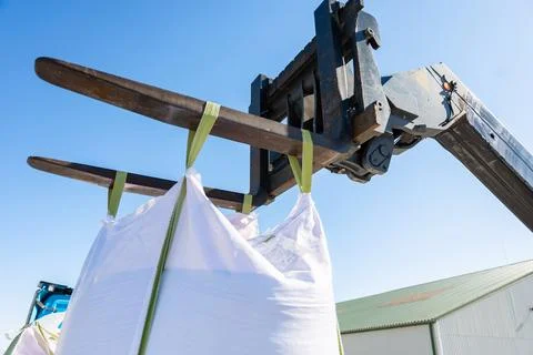 Telehandler Hoists Two White Bulk Bags With Extended Forks Daylight Photos