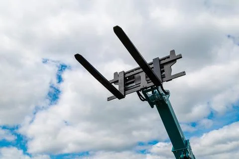 Telehandler lifting forks raised vertically on extended boom with forklift Stock Photos