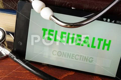Telehealth apps open in a smartphone and stethoscope. Stock Photos