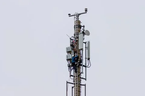 Telekom technicians perform work on a transmission tower Stock Photos