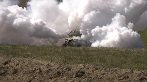 Teleoperationally-controlled smoke screen emitting from military vehicle Video stock 108379150