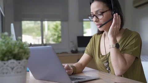 Teleoperator working in office with laptop and headset on Stock Footage 87095569
