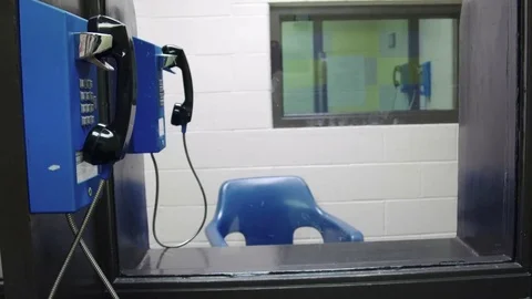 Telephone meeting area in jail prison Stock Footage