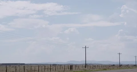 Telephone Poles with Train Passing in Background - West Texas USA Stock Footage 256049762