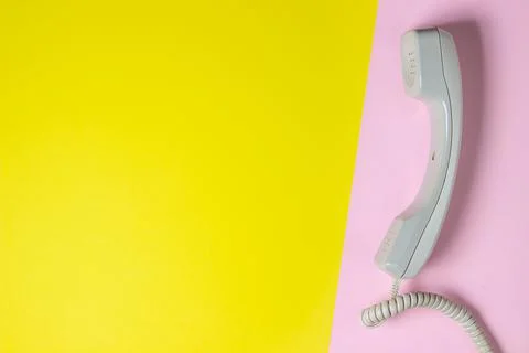 Telephone receiver on a geometric background. Colored background.  Stock Photos